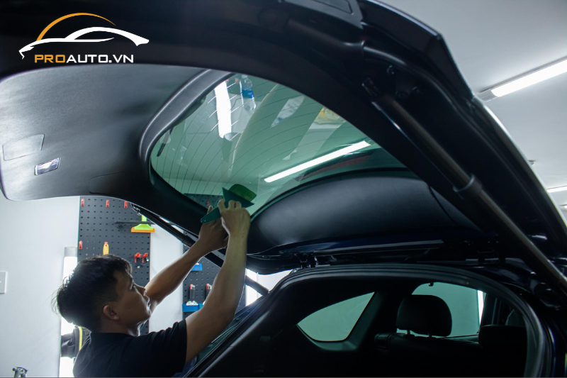 Kỹ thuật viên thi công dán phim cách nhiệt cho xe hơi