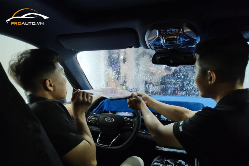 Kỹ thuật viên dán phim cách nhiệt cho kính lái ô tô